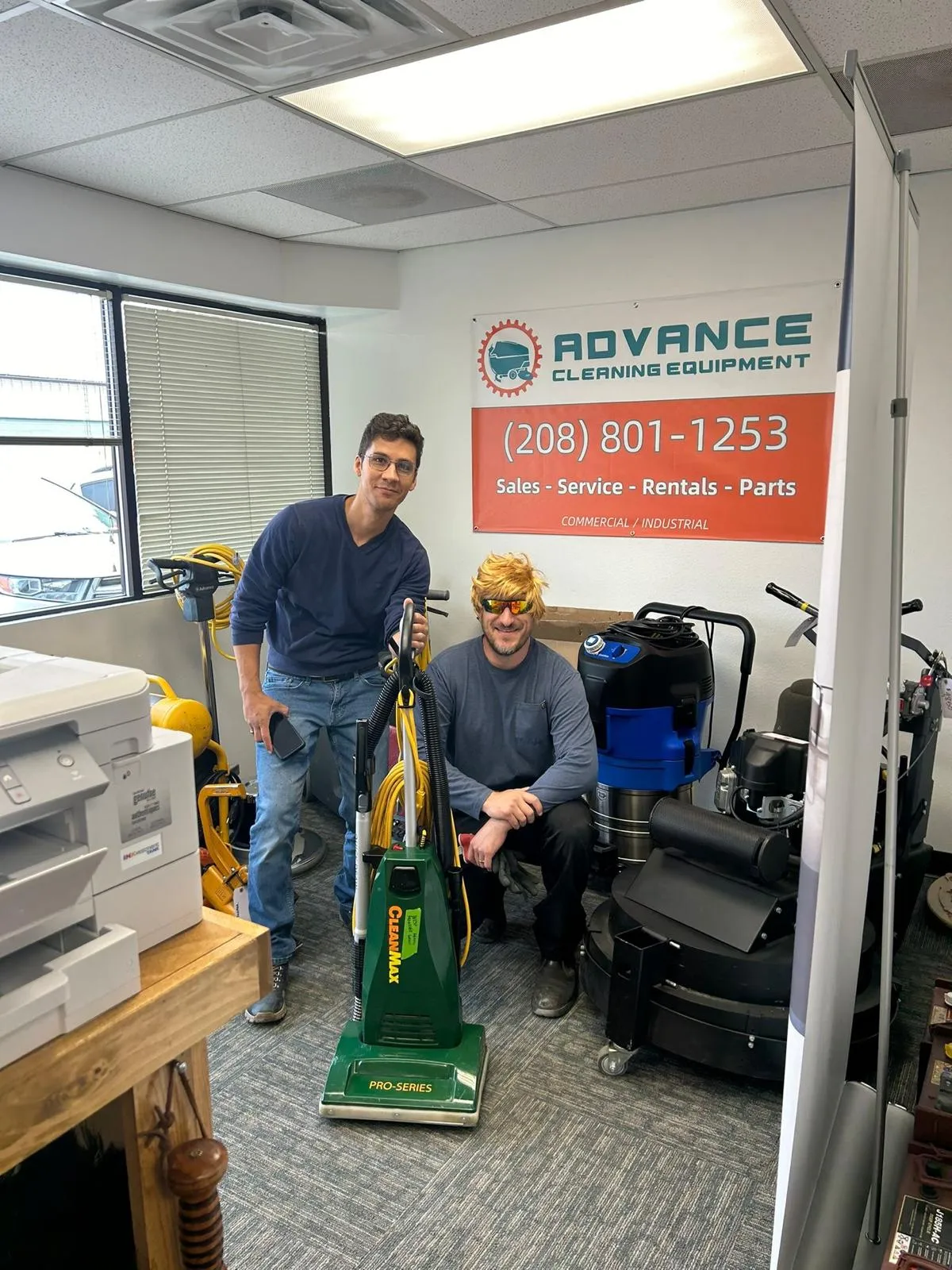 Advance Cleaning Equipment team members in the Boise shop with a CleanMax commercial vacuum