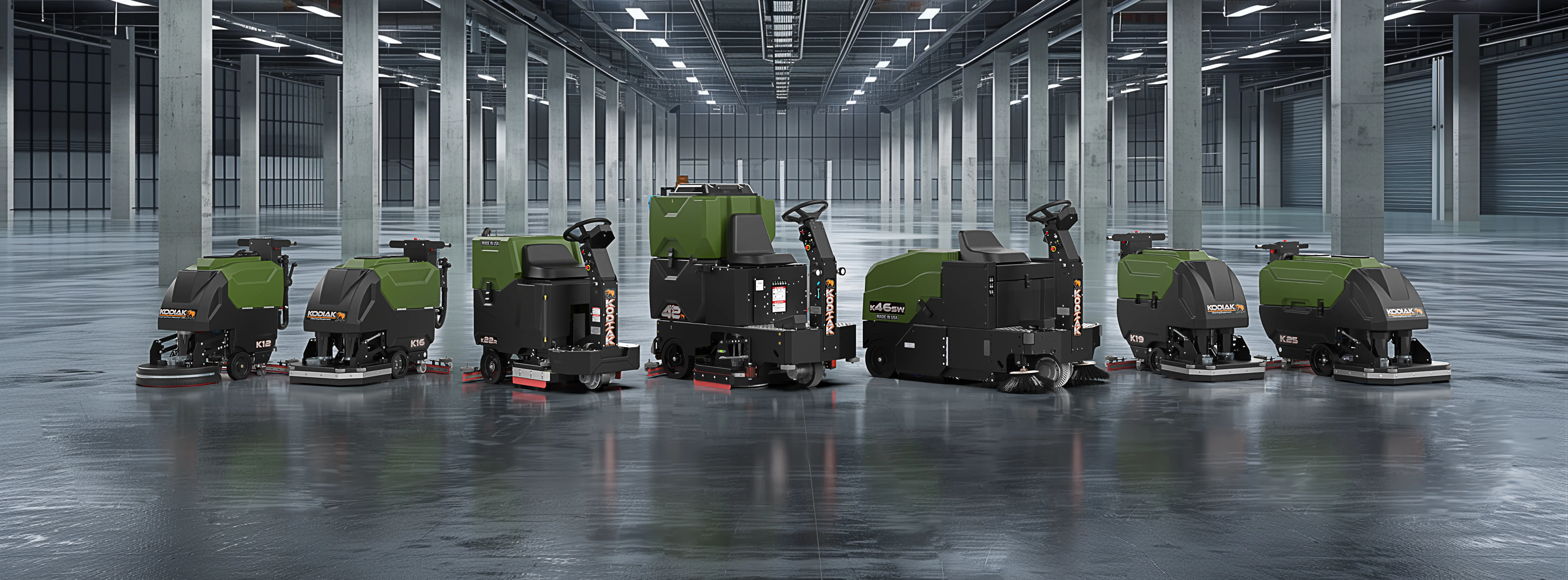 Lineup of four Kodiak walk-behind floor scrubbers, models K12 through K25, in a large warehouse